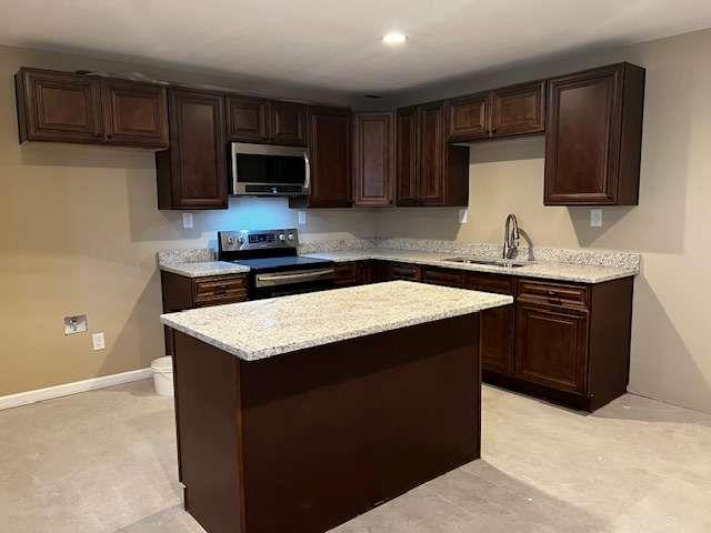 3721 Bogan Mill Road Northeast Buford, GA 30519 - Photo 37 of 41 a kitchen with stainless steel appliances a sink a stove a microwave and wooden cabinets