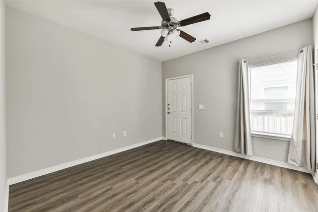 a bathroom with a granite countertop sink mirror vanity and toilet