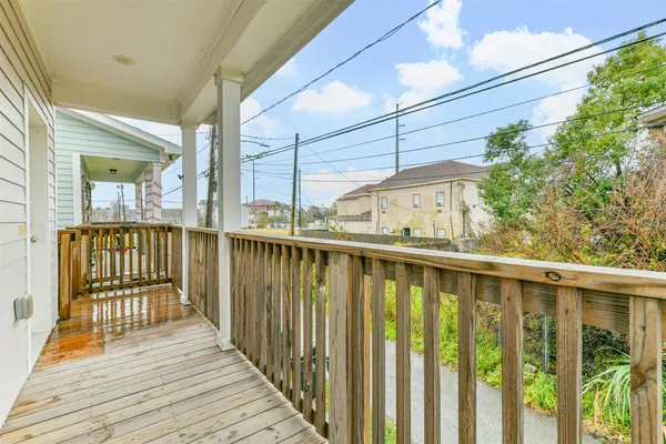 a view of a balcony with wooden floor
