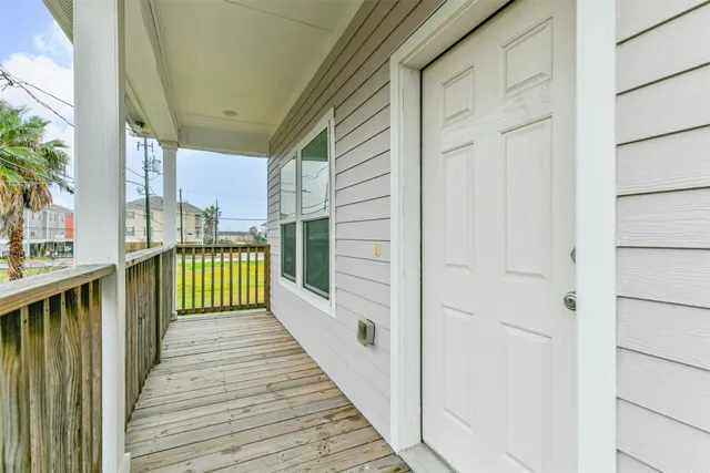 a view of a balcony with wooden floor