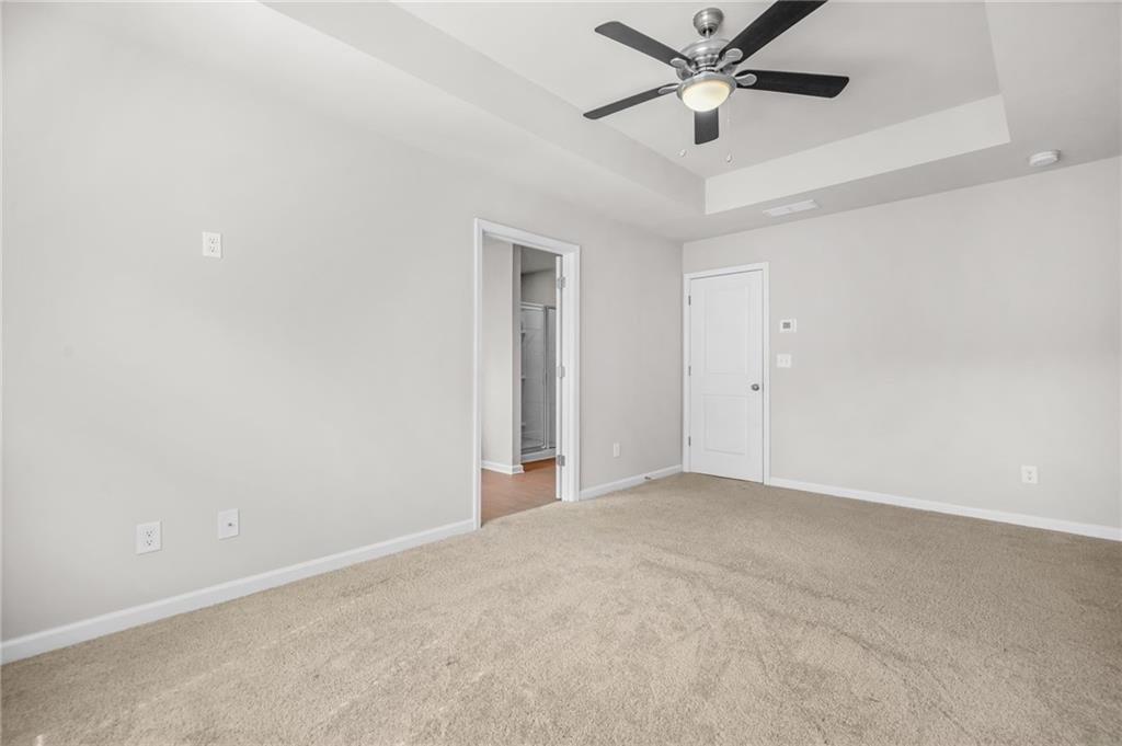 3181 Meadowstone Lane Southwest Atlanta, GA 30331 - Photo 13 of 27 an empty room with a ceiling fan and a ceiling fan
