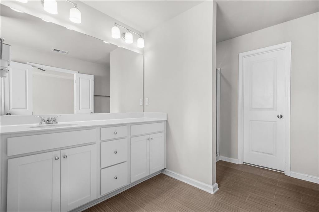 3181 Meadowstone Lane Southwest Atlanta, GA 30331 - Photo 15 of 27 a bathroom with a double vanity sink and a mirror