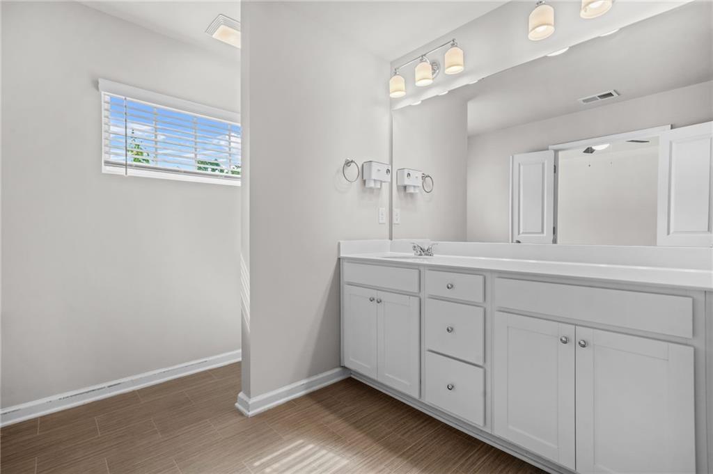 3181 Meadowstone Lane Southwest Atlanta, GA 30331 - Photo 17 of 27 a spacious bathroom with a double vanity sink and a mirror