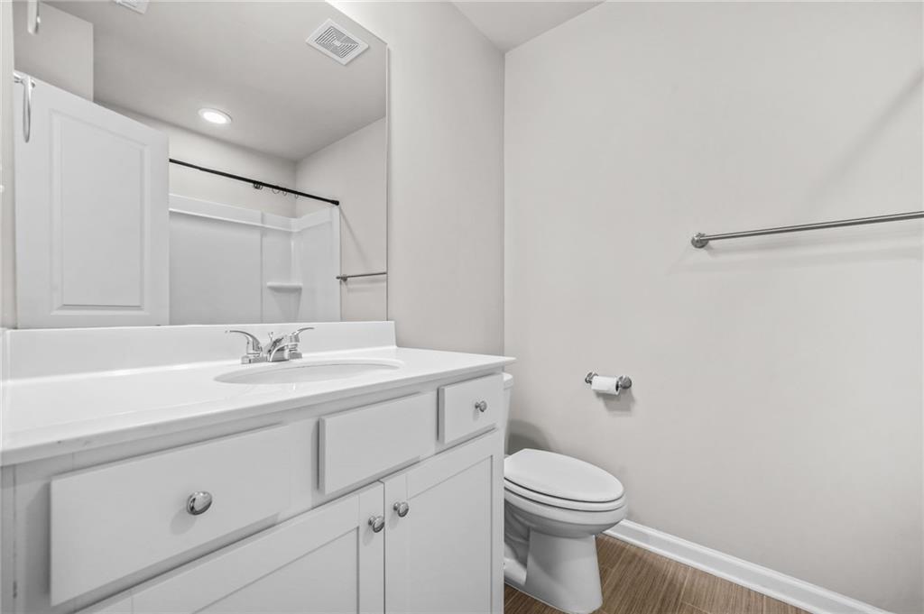 3181 Meadowstone Lane Southwest Atlanta, GA 30331 - Photo 23 of 27 a bathroom with a toilet a sink a vanity and mirror