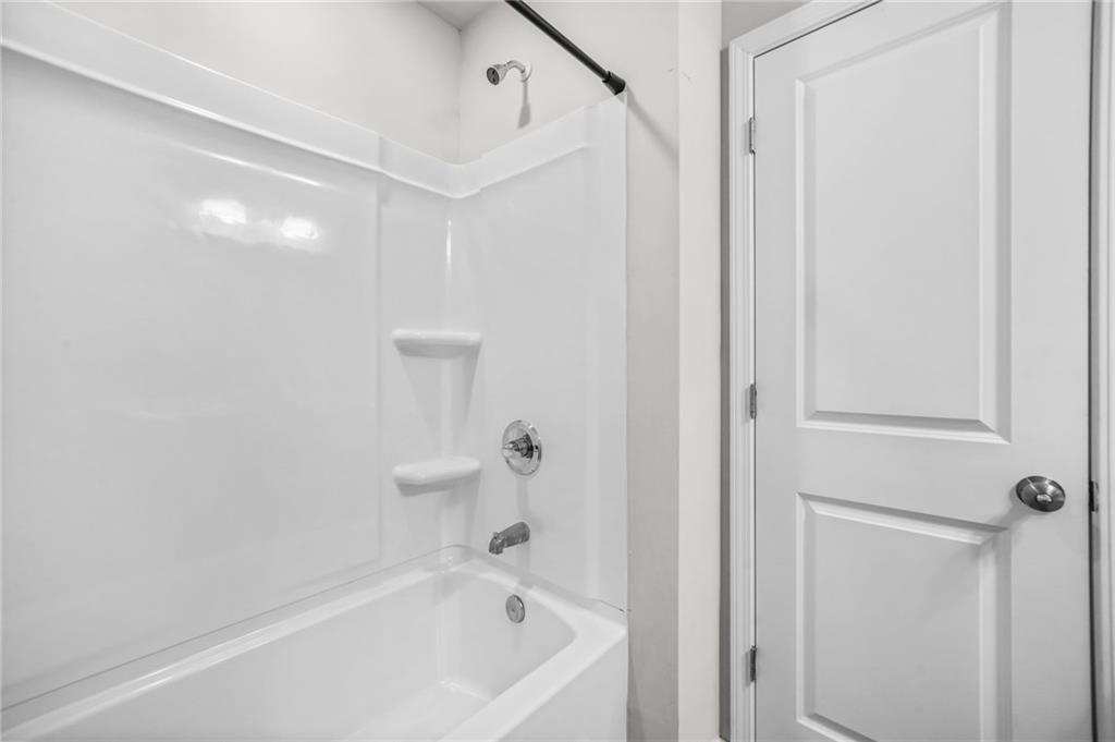 3181 Meadowstone Lane Southwest Atlanta, GA 30331 - Photo 24 of 27 a bathroom with a bathtub and shower