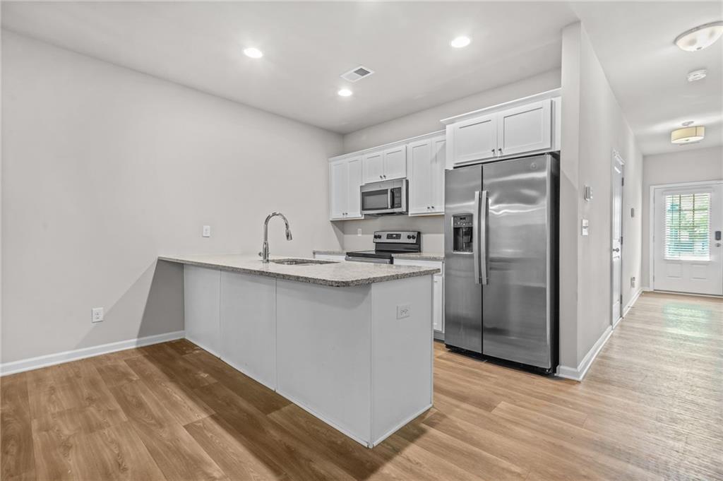 3181 Meadowstone Lane Southwest Atlanta, GA 30331 - Photo 8 of 27 a kitchen with refrigerator and cabinets