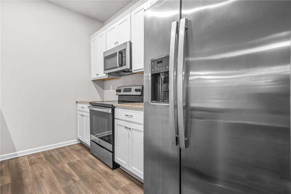 3181 Meadowstone Lane Southwest Atlanta, GA 30331 - Photo 9 of 27 a kitchen with appliances and cabinets