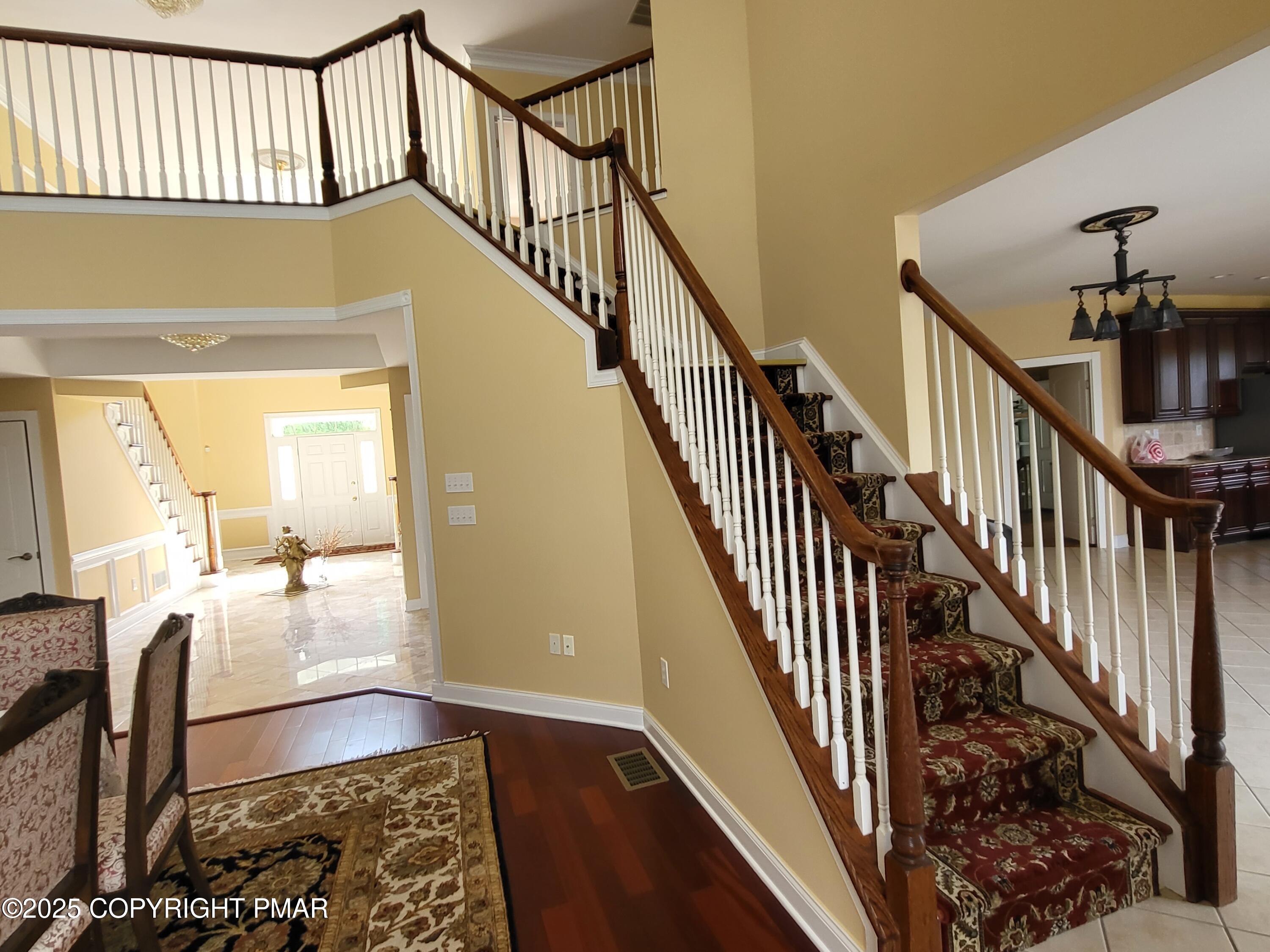 229 Rising Meadow Way East Stroudsburg, PA 18302 - Photo 20 of 73 a view of staircase with wooden floor and a rug