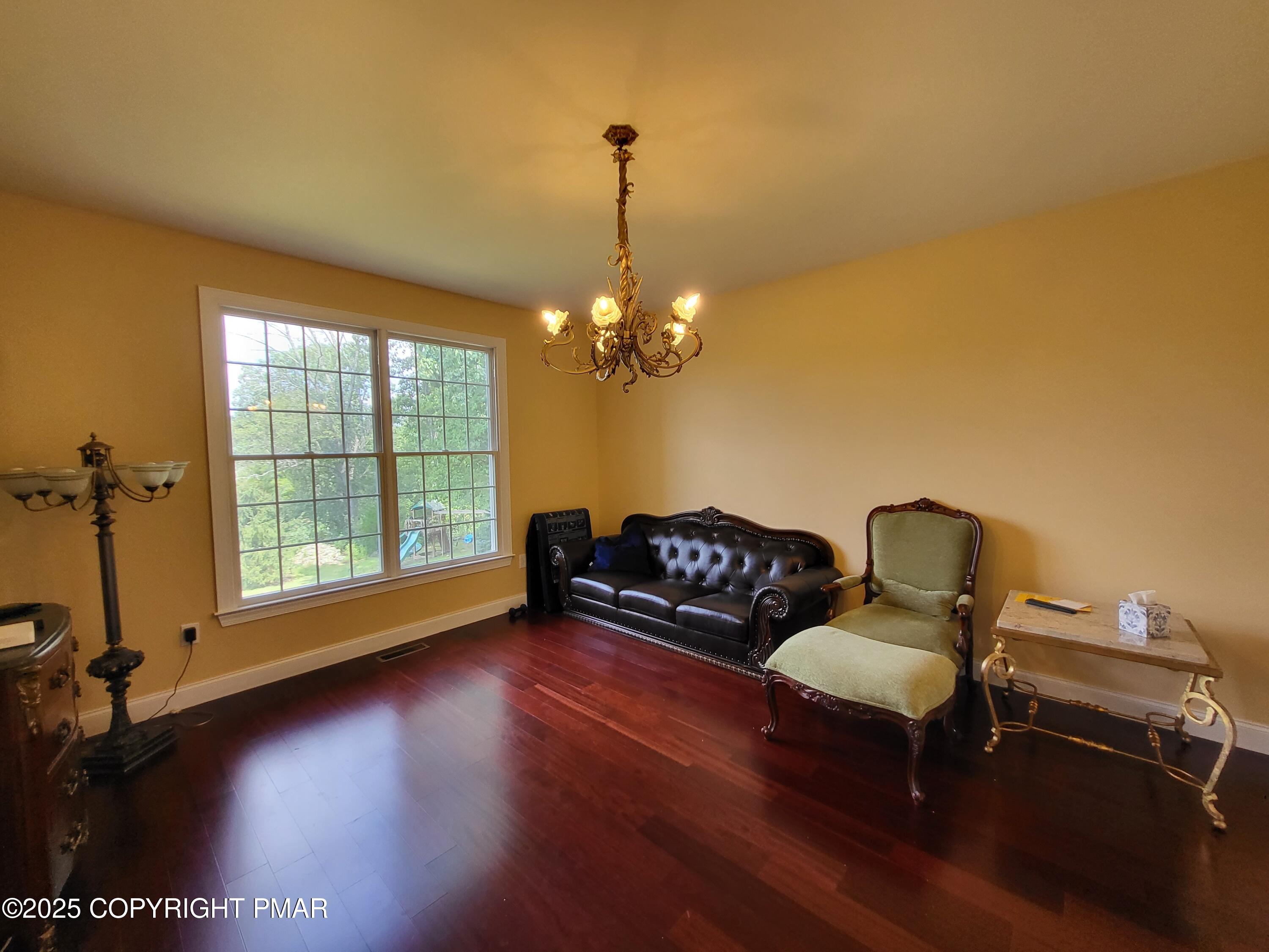 229 Rising Meadow Way East Stroudsburg, PA 18302 - Photo 21 of 73 a living room with furniture and a chandelier