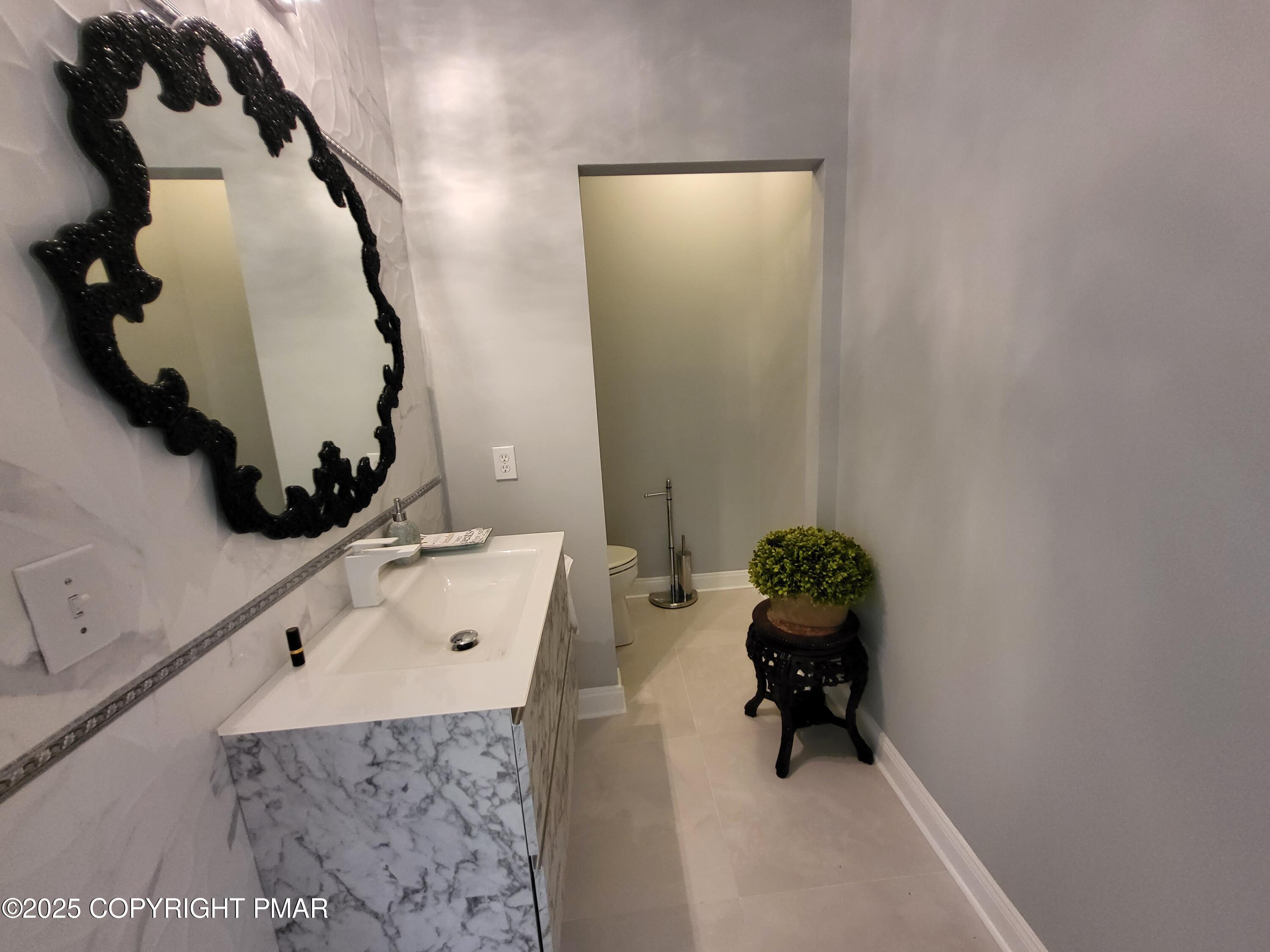 229 Rising Meadow Way East Stroudsburg, PA 18302 - Photo 28 of 73 a bathroom with a sink and a mirror