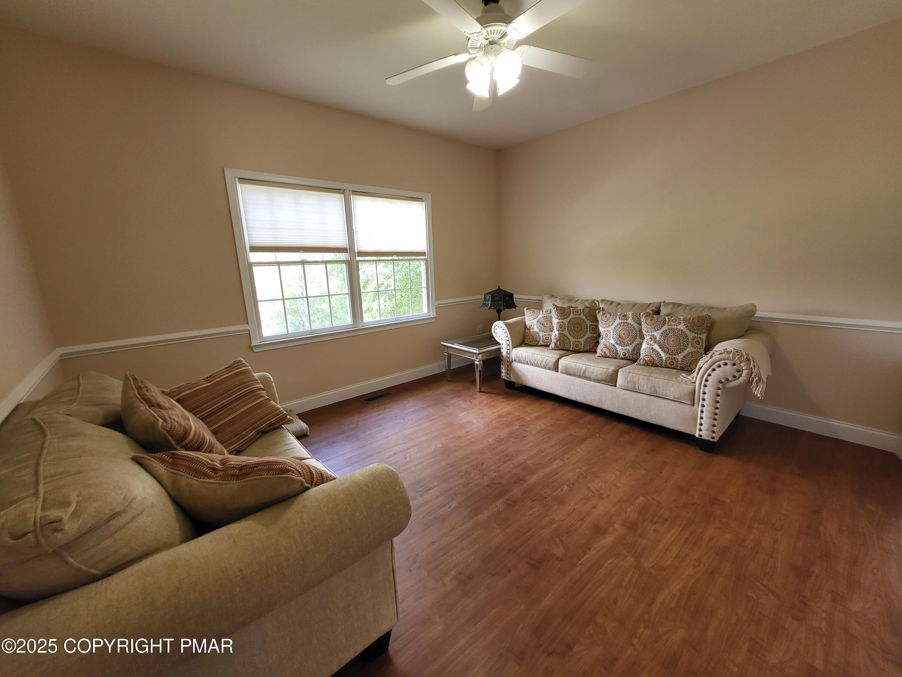 229 Rising Meadow Way East Stroudsburg, PA 18302 - Photo 43 of 73 a living room with furniture and a large window