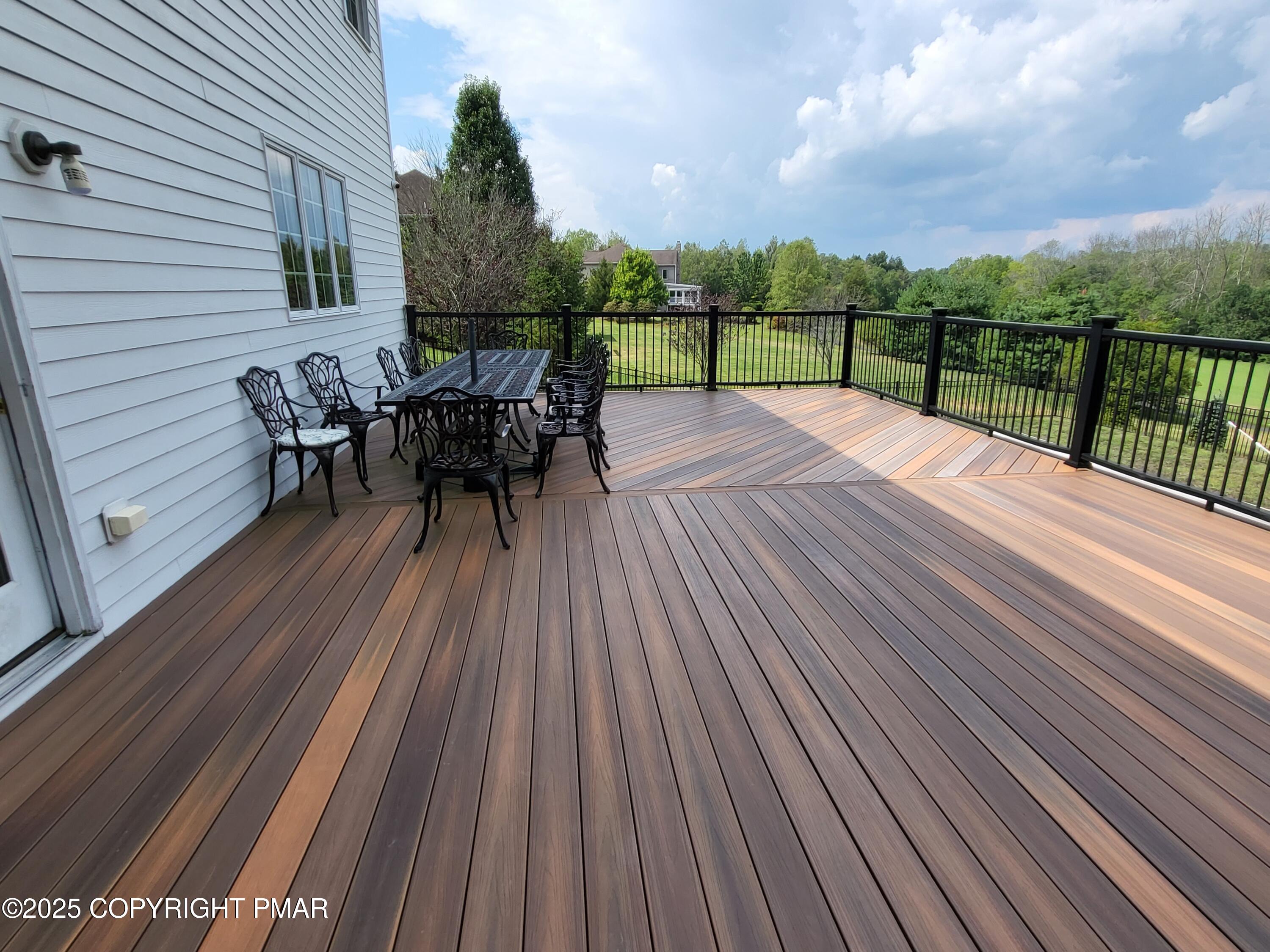 229 Rising Meadow Way East Stroudsburg, PA 18302 - Photo 61 of 73 a view of a roof deck with table and chairs with wooden floor and fence