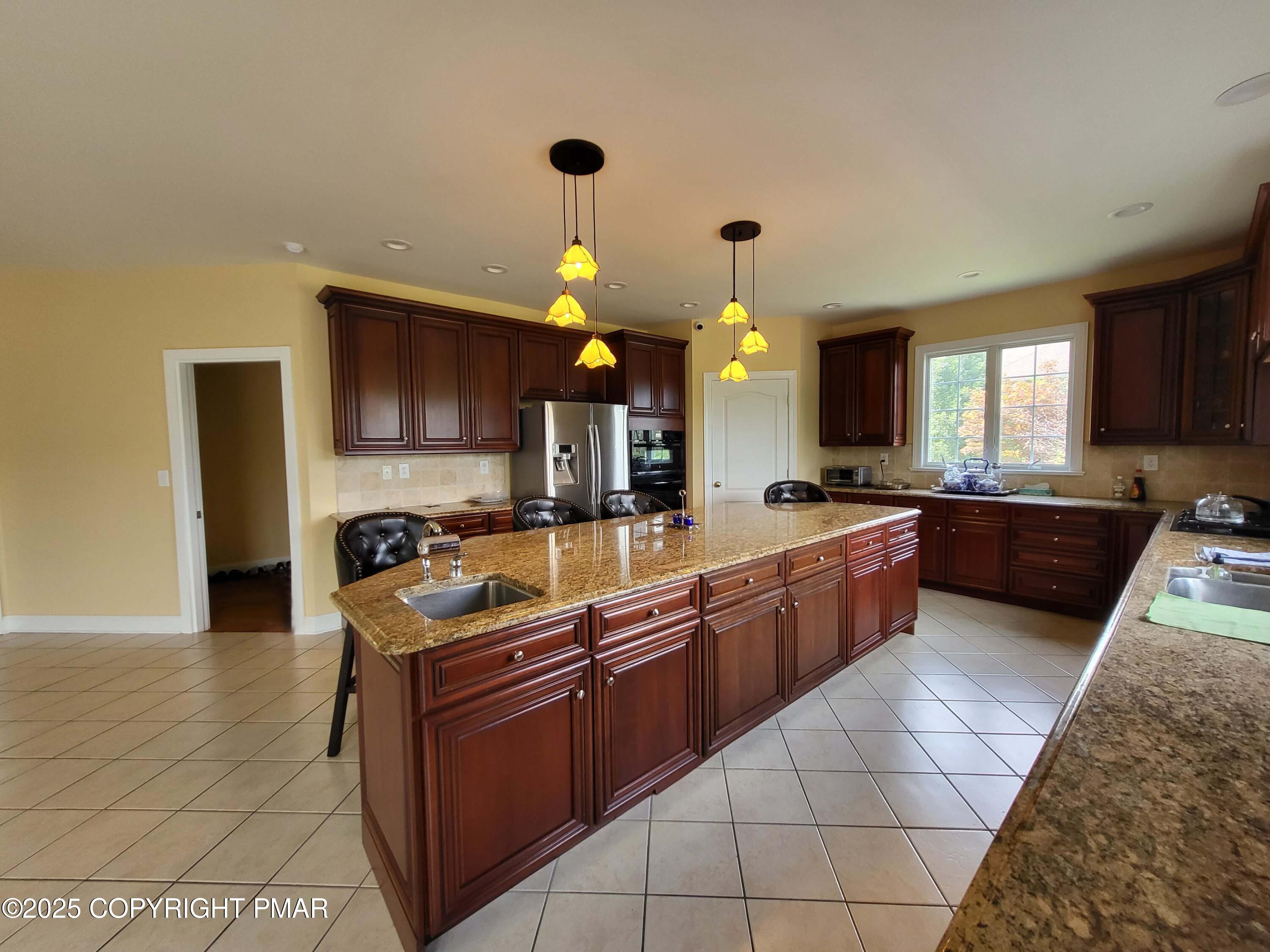 229 Rising Meadow Way East Stroudsburg, PA 18302 - Photo 10 of 73 a large kitchen with a stove a sink a counter space and cabinets