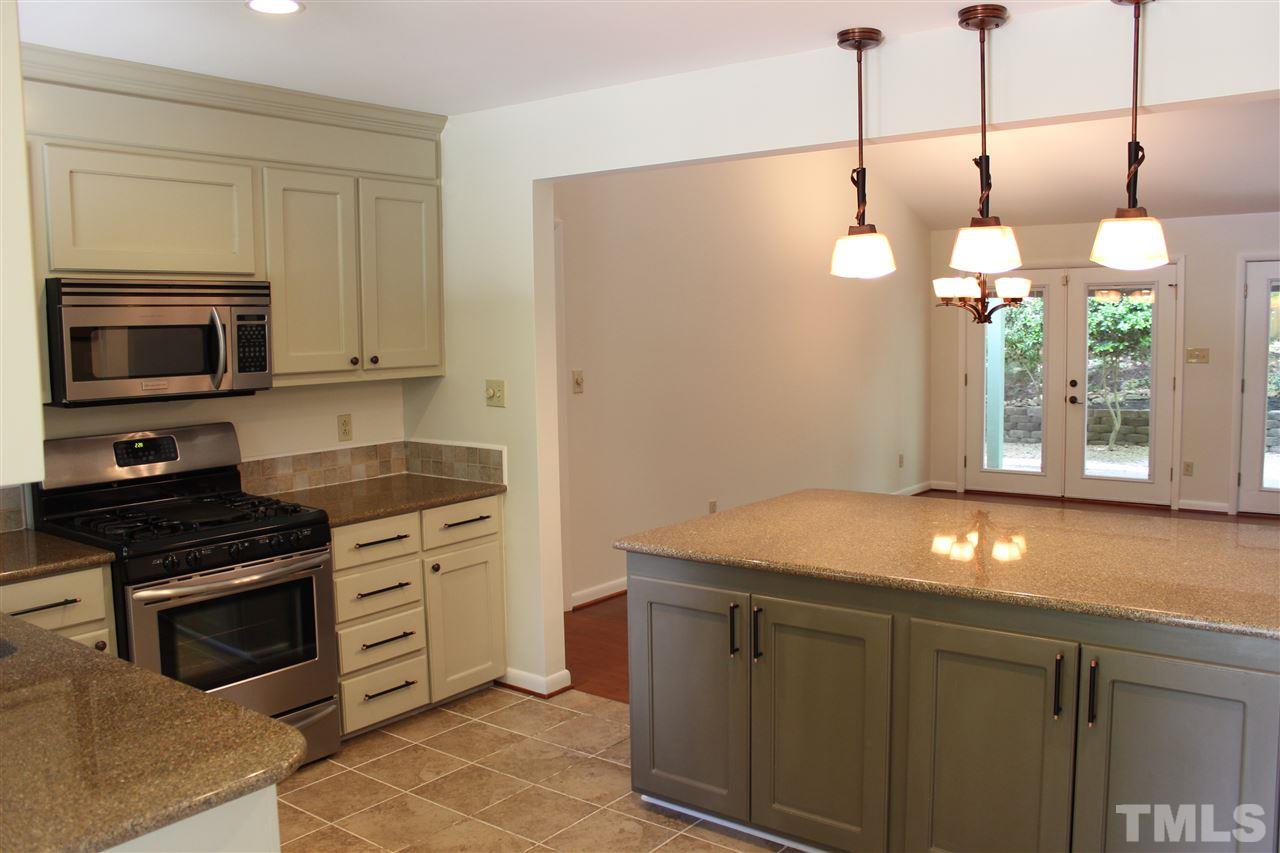 6201 Coldwater Court Raleigh, NC 27612 - Photo 8 of 25 Pendant Lighting over the Side Island! TONS of cabinet storage space and bar seating on other side of Island!