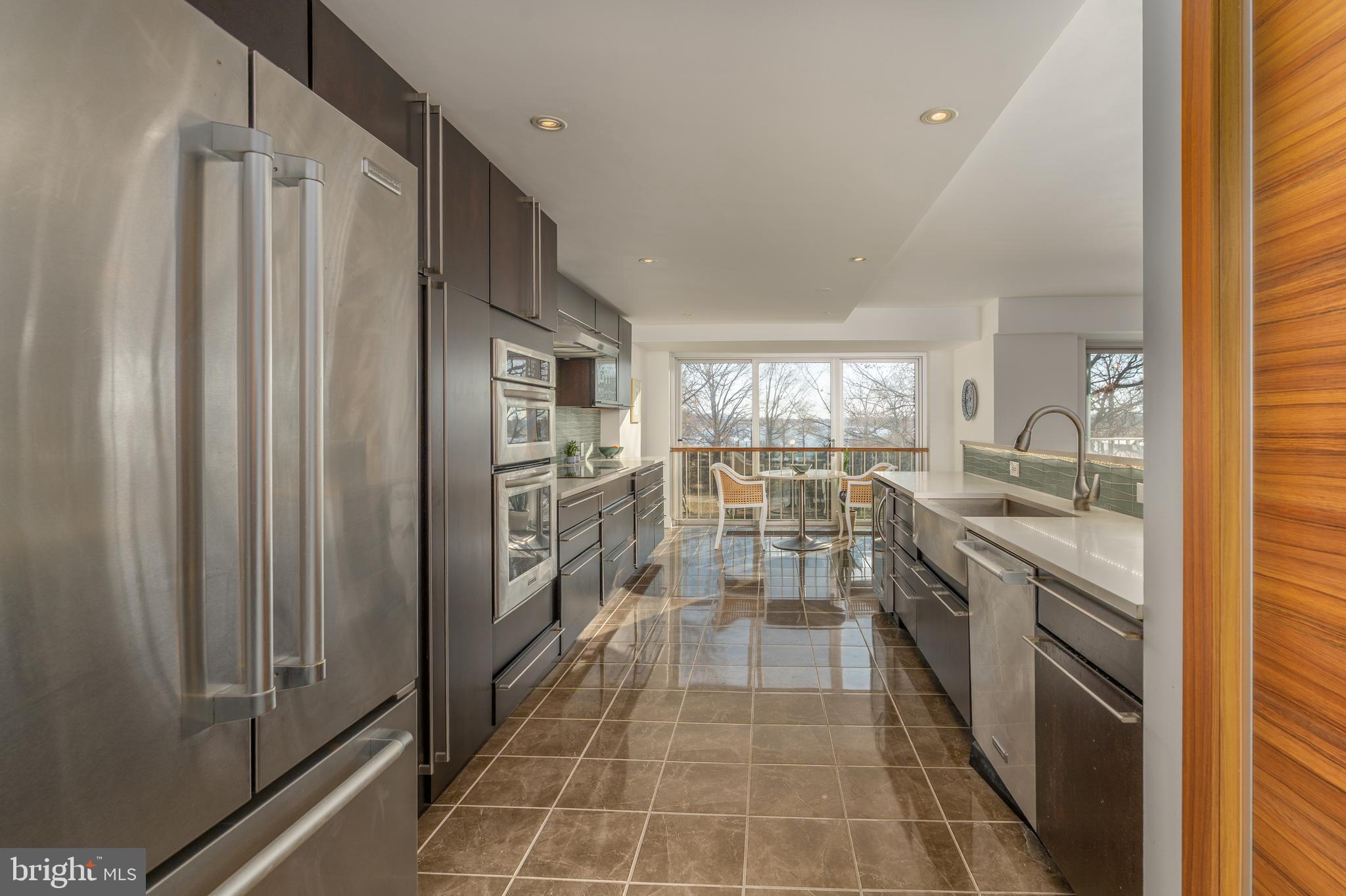 550 N Street Southwest, Unit S201 Washington, DC 20024 - Photo 16 of 63 a kitchen with stainless steel appliances a refrigerator sink and stove
