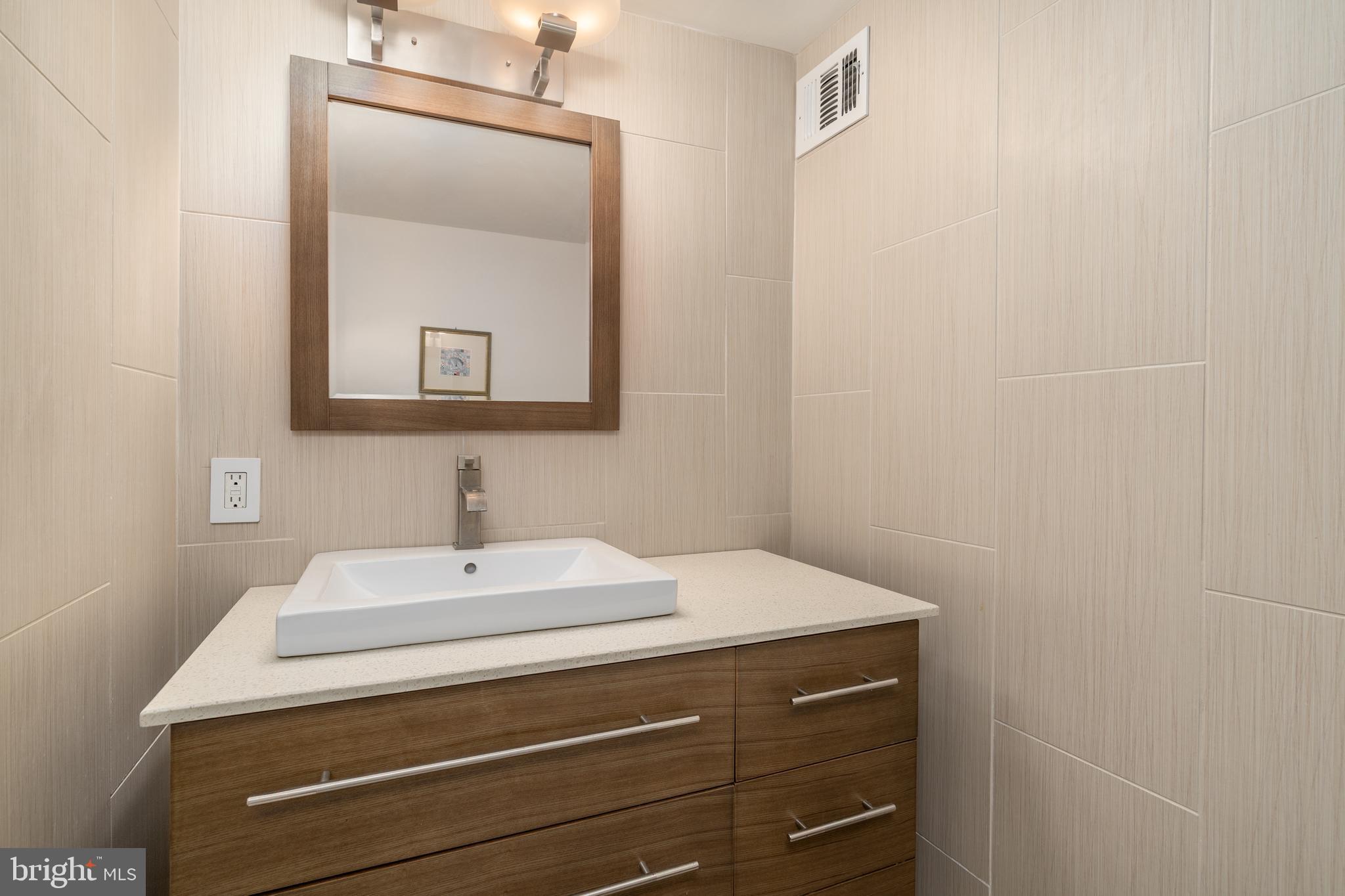 550 N Street Southwest, Unit S201 Washington, DC 20024 - Photo 30 of 63 a bathroom with a sink and a mirror