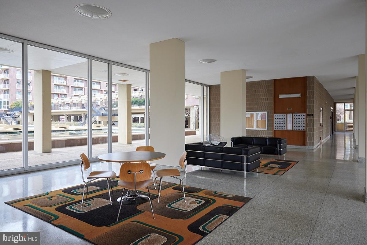 550 N Street Southwest, Unit S201 Washington, DC 20024 - Photo 59 of 63 a living room with furniture a rug and a large window