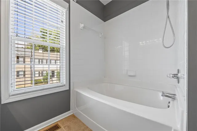 a white bath tub with a shower