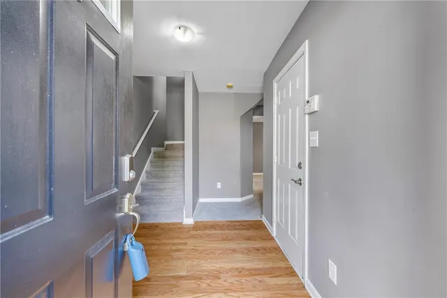 an empty room with windows and chandelier fan