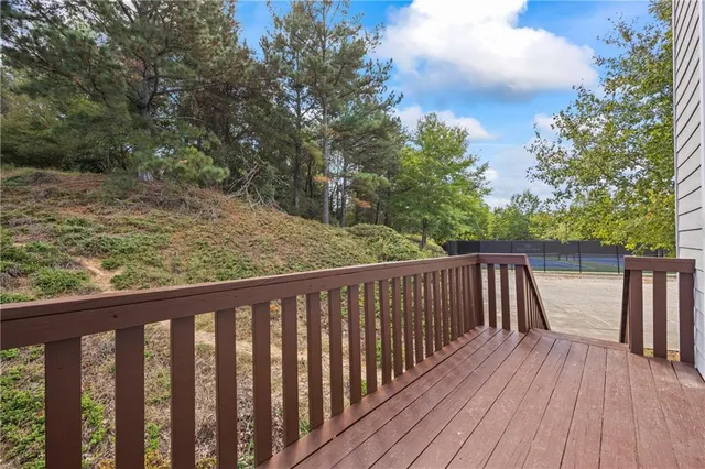 a view of balcony with wooden floor and fence