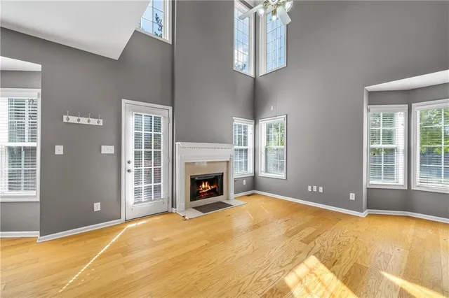 a view of an empty room with a fireplace and chandelier