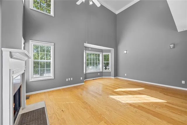 a view of an empty room with a fireplace and a window