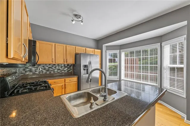 a room with wooden floor and a large window