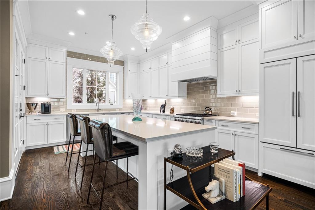 3715 Peachtree Road, Unit 2 Atlanta, GA 30319 - Photo 15 of 51 a kitchen with a dining table chairs sink and cabinets