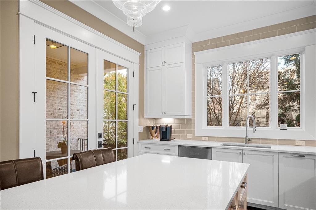 3715 Peachtree Road, Unit 2 Atlanta, GA 30319 - Photo 23 of 51 a large white kitchen with a large window and a counter top space