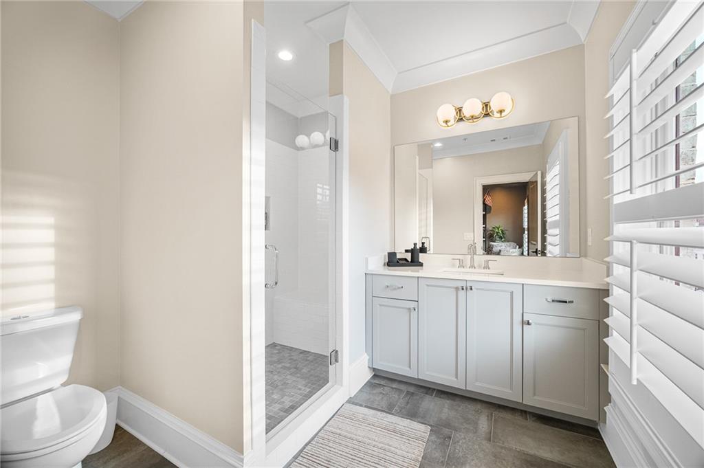 3715 Peachtree Road, Unit 2 Atlanta, GA 30319 - Photo 44 of 51 a bathroom with a sink a toilet a mirror and shower