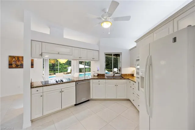 a kitchen with a sink and white cabinets
