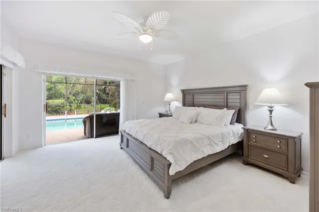 a spacious bedroom with a bed and a large window