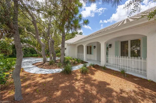 a view of a house with a tree in the background