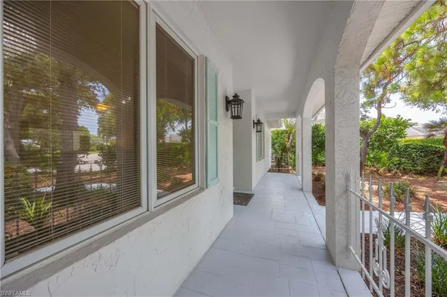 a view of a glass door with a yard from a balcony