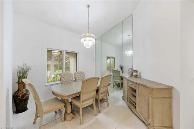 a view of a dining room with furniture and chandelier
