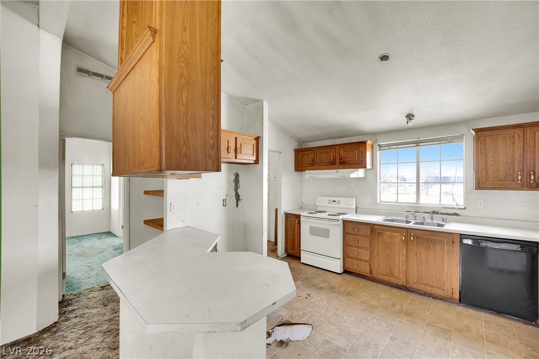 4361 Maple Road Pahrump, NV 89048 - Photo 15 of 46 A well-lit kitchen with ample cabinetry and a window overlooking scenic surroundings.
