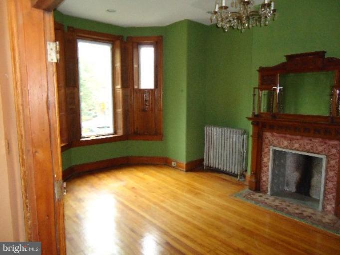 54 R Street Northeast Washington, DC 20002 - Photo 3 of 6 a view of an empty room with a window and fire place