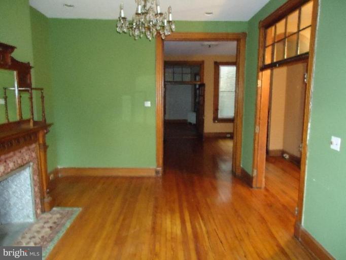 54 R Street Northeast Washington, DC 20002 - Photo 4 of 6 a view of a room with wooden floor a chandelier and windows