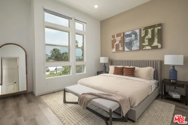 a bedroom with a large bed and a window