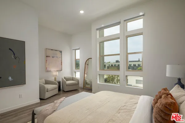 a bedroom with bed and large window