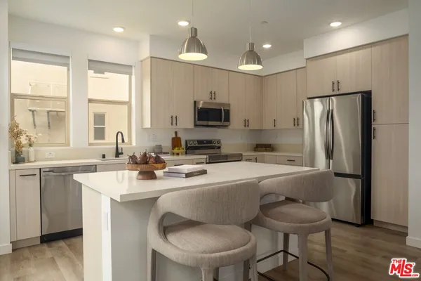a kitchen with refrigerator a sink and a refrigerator