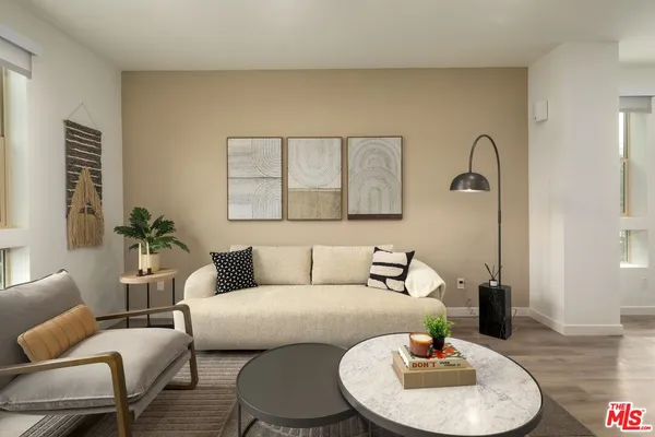 a living room with furniture and a wooden floor