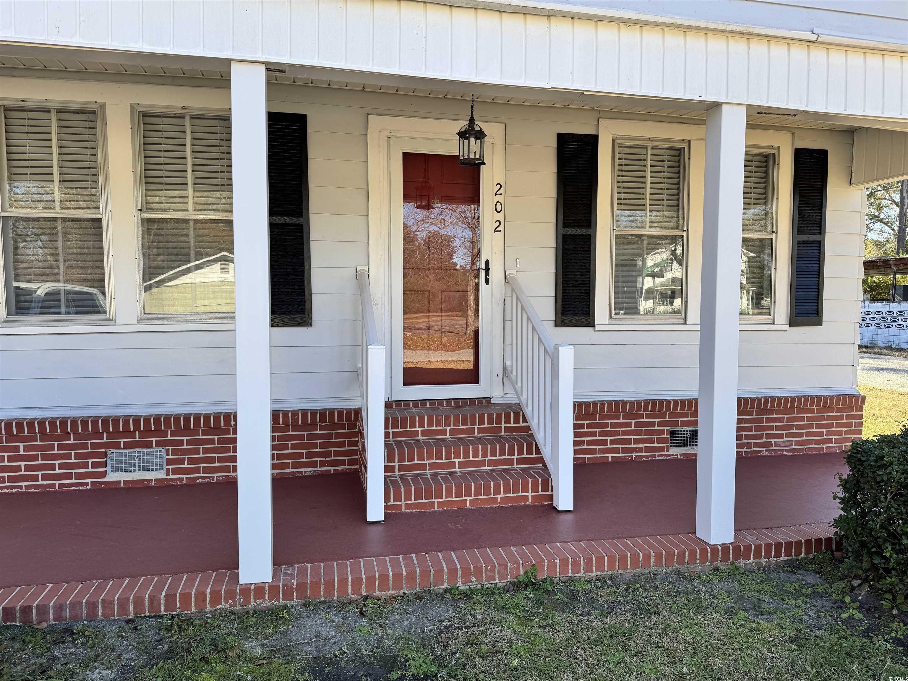 202 Lewis Street Mullins, SC 29574 - Photo 17 of 23 Doorway to property with covered porch