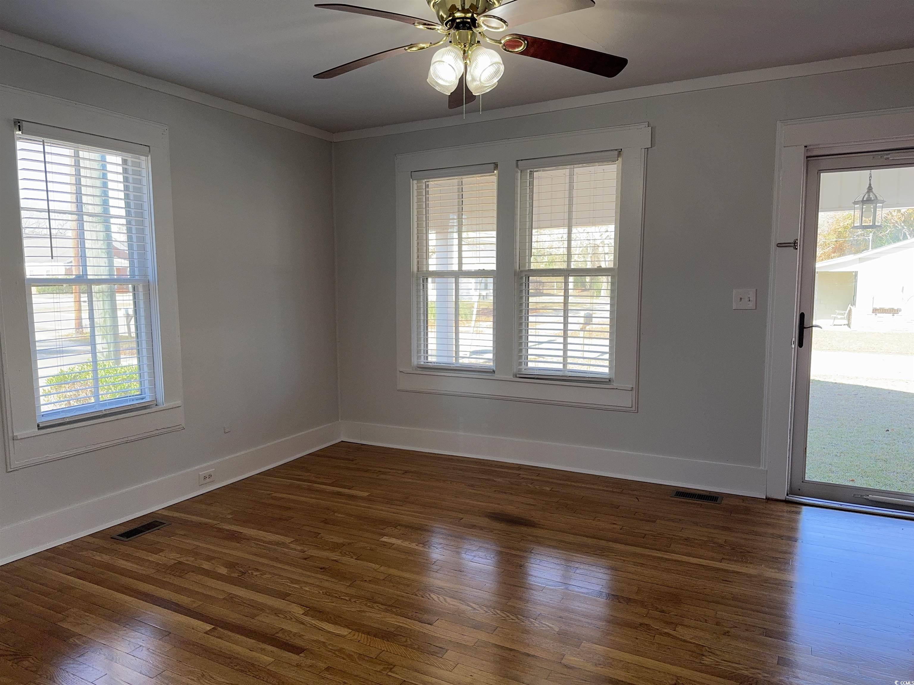 202 Lewis Street Mullins, SC 29574 - Photo 5 of 23 Unfurnished room with ceiling fan, plenty of natur