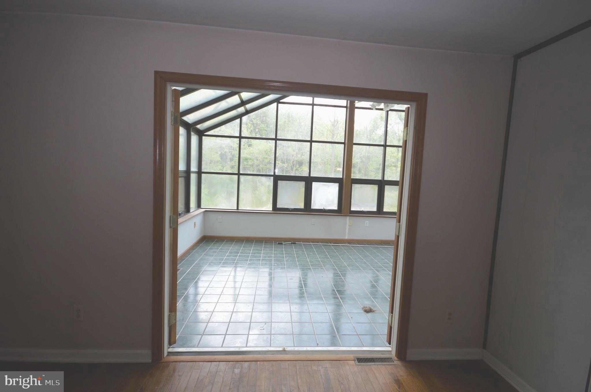 749 Street Road Cochranville, PA 19330 - Photo 18 of 35 Front living room looking into Sun room