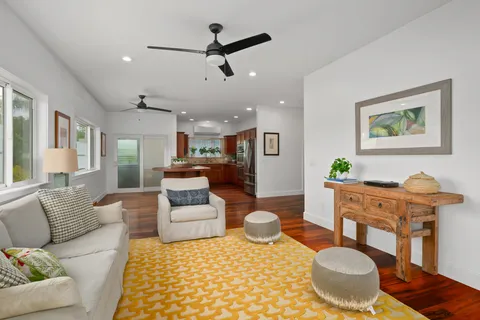 a living room with furniture and a dining table
