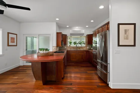 a kitchen with stainless steel appliances granite countertop a sink stove and refrigerator