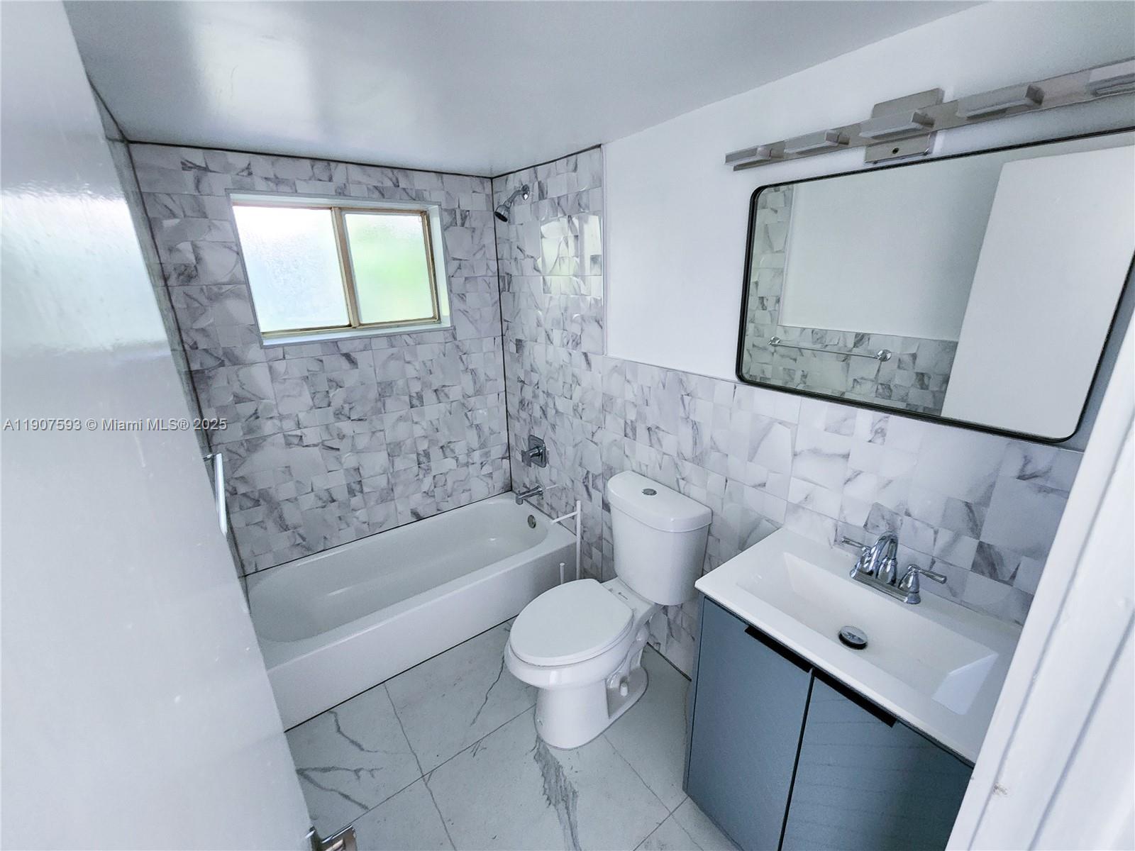 2465 Southwest 27th Street, Unit 2 Miami, FL 33133 - Photo 14 of 19 a bathroom with a sink toilet and shower