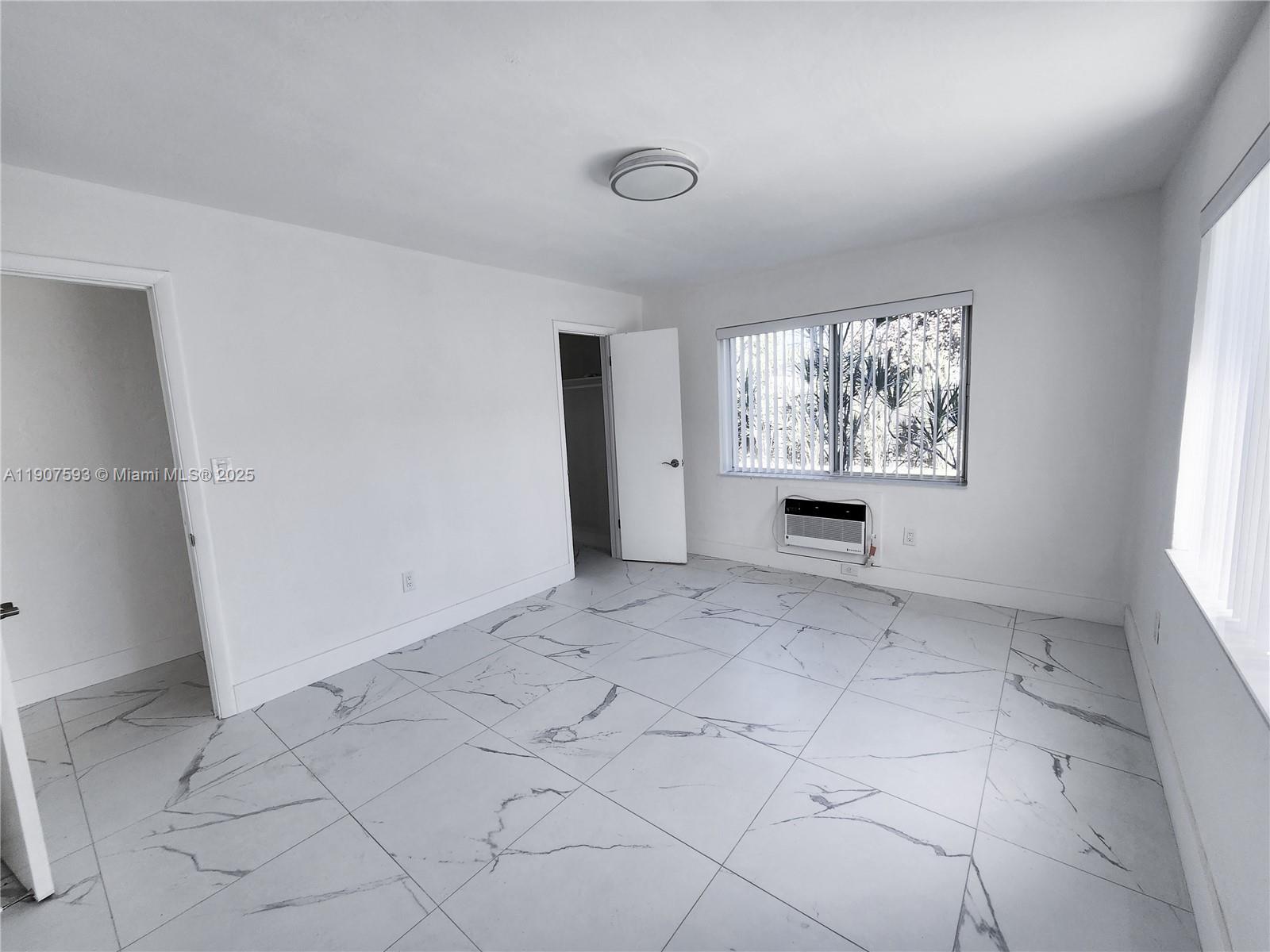 2465 Southwest 27th Street, Unit 2 Miami, FL 33133 - Photo 16 of 19 an empty room with windows