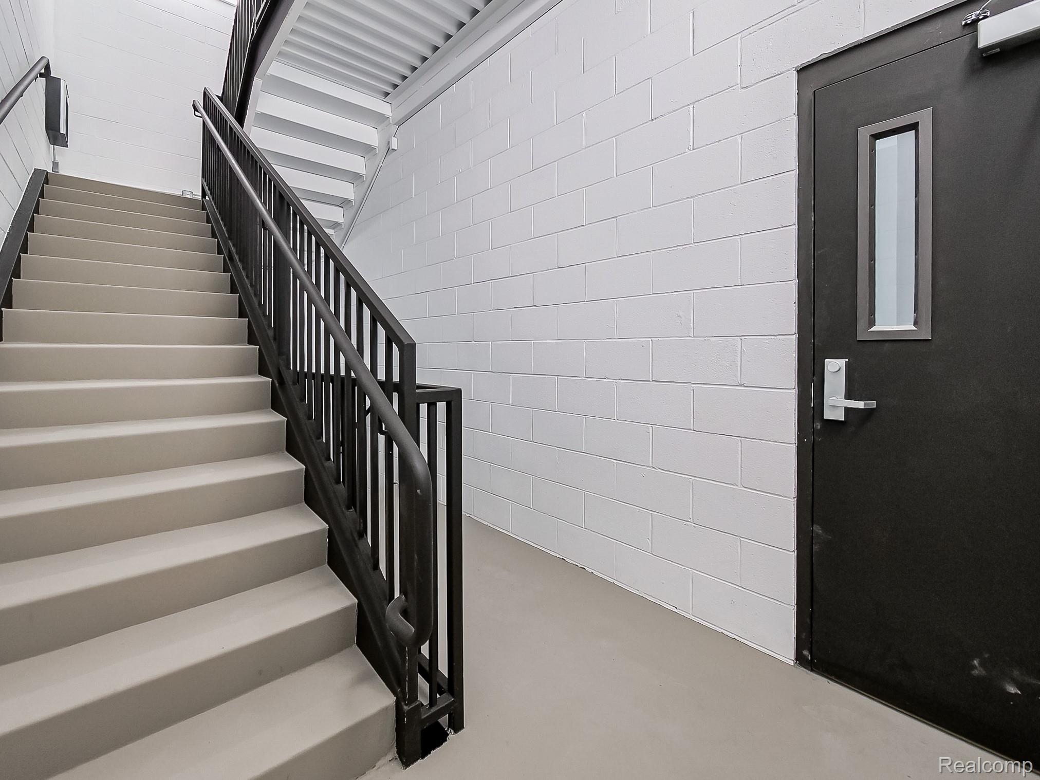 31480 Warren Road, Unit 101 Westland, MI 48185 - Photo 20 of 26 Staircase with concrete floors and elevator